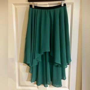 Crepe-like flowy green high-low skirt with black elastic waist.